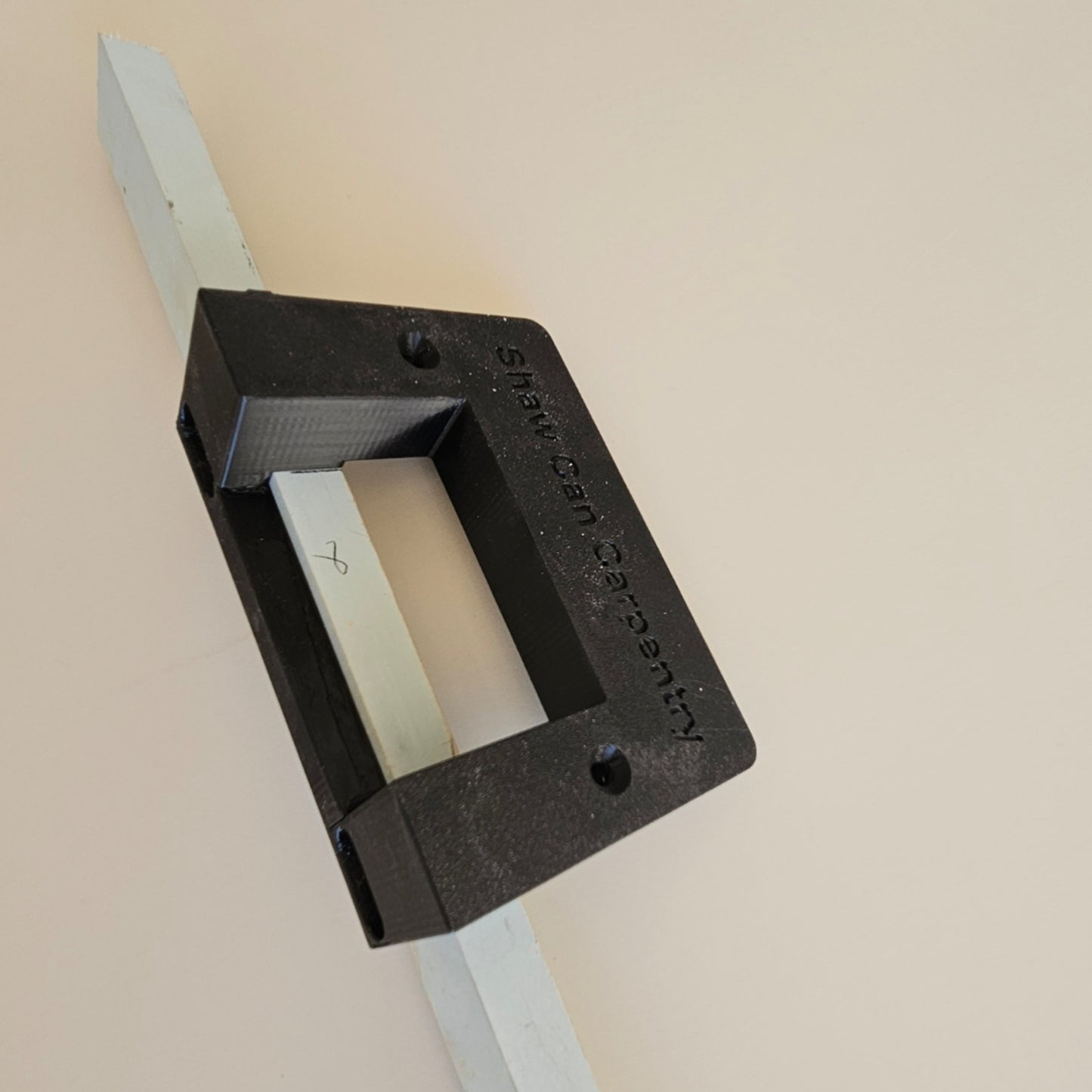 Close-up of Shaw Can Carpentry modular hinge routing jig showing the precision template for 85mm and 100mm door hinges.